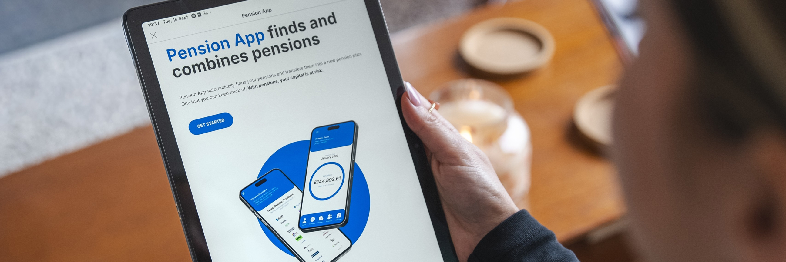 An image showing someone holding a tablet, displaying the Pension App website homepage.