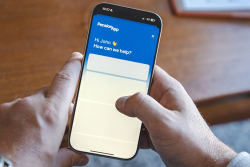 An image showing someone holding a phone, displaying the Pension App chat support page.